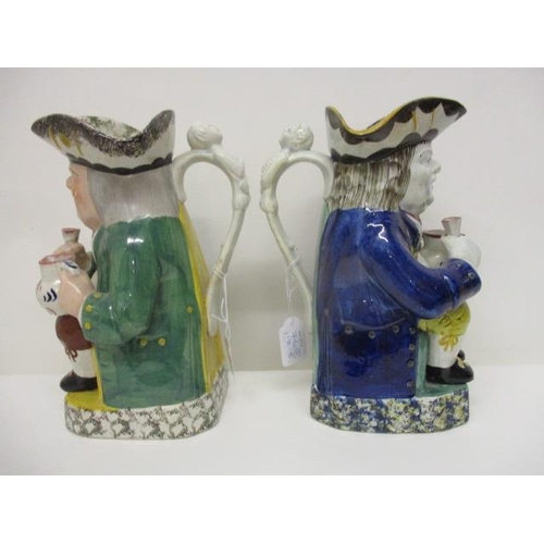 76 - An early 18th century and a 19th century Toby jug, each holding a jug and a glass on a plinth, 10