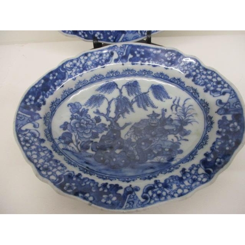 78 - A pair of late 18th century Chinese blue and white oval dishes decorated with a tree, flowers and ob... 