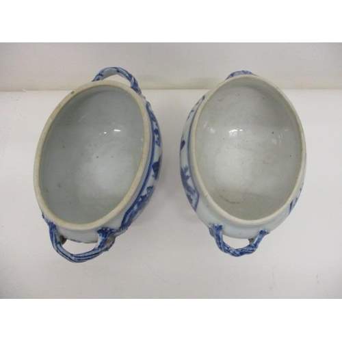 79 - A pair of mid 18th century Chinese blue and white oval tureens with twin crossover handles on a spla... 