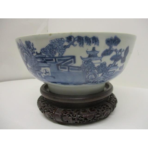 80 - A late 18th century Chinese blue and white bowl, the interior decorated with flowers and foliage and... 