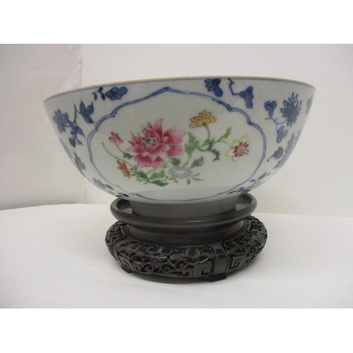 81 - A late 18th century Chinese bowl decorated with panels of polychrome flowers, blue and white flowers... 