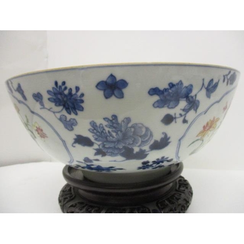 81 - A late 18th century Chinese bowl decorated with panels of polychrome flowers, blue and white flowers... 