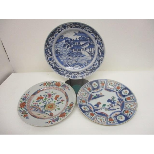 82 - Three late 18th century Chinese plates, one decorated with a band of dragons, a river, a bridge, a f... 