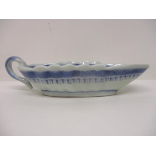 83 - An early 19th century Chinese Canton blue and white sauce boat decorated with a river scene and buil... 