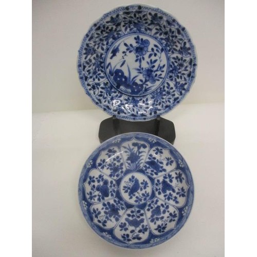 84 - Two mid 18th century Chinese blue and white dishes, each decorated with panels of flowers and foliag... 