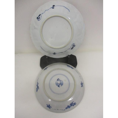 84 - Two mid 18th century Chinese blue and white dishes, each decorated with panels of flowers and foliag... 