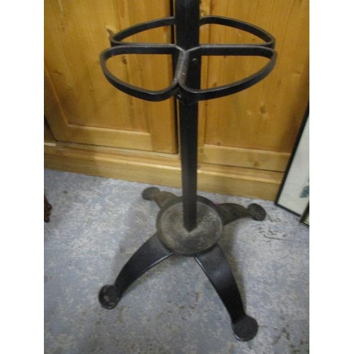 130 - A wrought iron hat and stick stand, on splayed legs