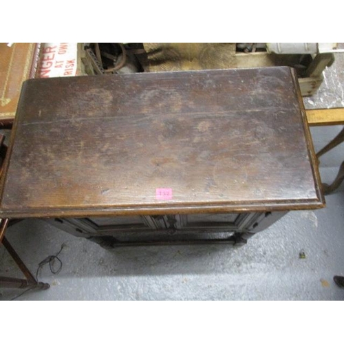 132 - A 1930s carved oak, twin door cabinet, raised on turned block legs, 29