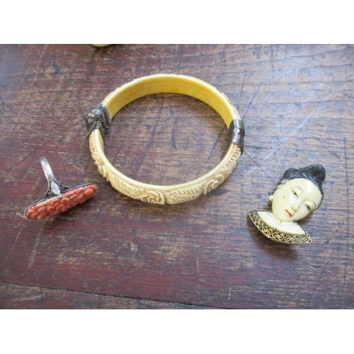 67 - Chinese and other jewellery to include an ivory bracelet, a brooch fashioned as a face and a coral r... 