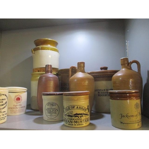 370 - A quantity of stoneware bottles and stoneware advertising jars to include Stilton and Marmalade