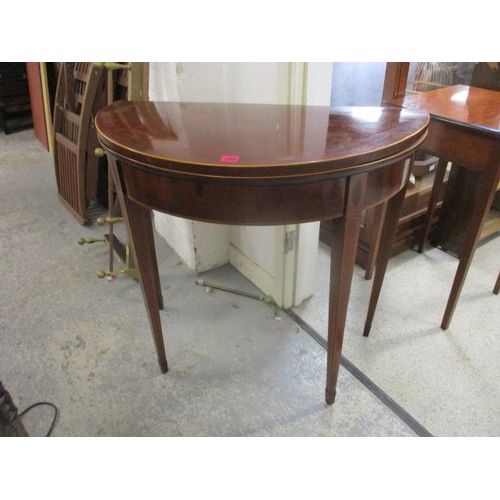 190 - A George III string inlaid mahogany D-shaped card table with a brown leather surface, raised on squa... 