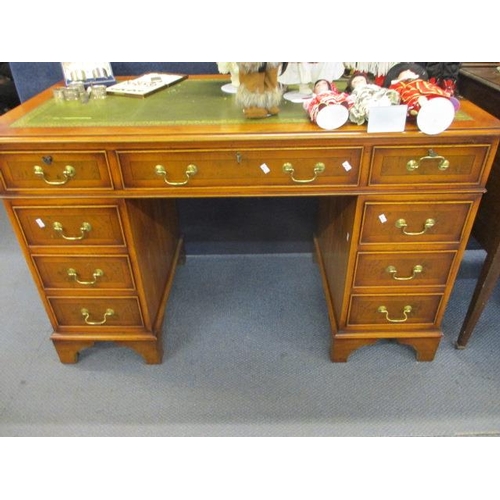 193 - A reproduction yew pedestal desk with green leather scriber