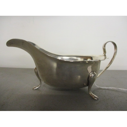 70B - An early 20th century silver sauce boat standing on three cabriole legs, dated Sheffield 1911, maker... 