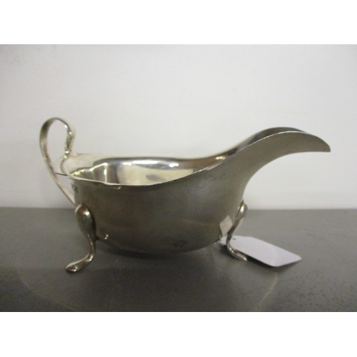 70B - An early 20th century silver sauce boat standing on three cabriole legs, dated Sheffield 1911, maker... 