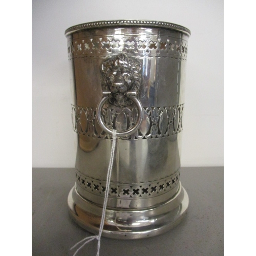 70C - An early 20th century silver bottle coaster having pierced borders, beaded rim and lion mask and rin... 