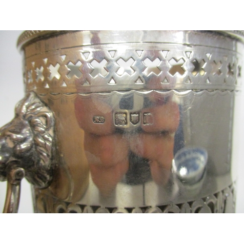 70C - An early 20th century silver bottle coaster having pierced borders, beaded rim and lion mask and rin... 