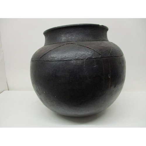 180 - A 19th century South African black, brown/red glazed clay pot with incised decoration, 14