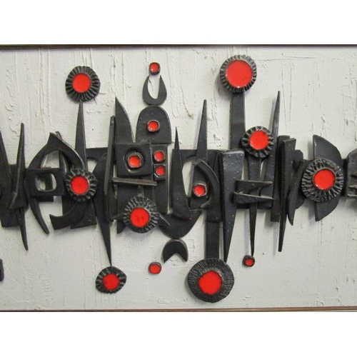 41 - A retro circa 1970 studio pottery wall picture, geometric motifs in relief in red and black glazes, ... 