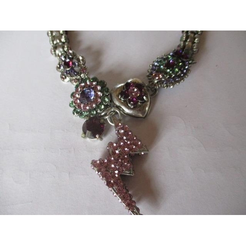 96 - Rodrigo Otazu - a white metal necklace with Swarovski coloured crystals and various pendants, 16