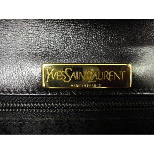 99 - A vintage Yves Saint Laurent leather shoulder bag with gilt chain handle and central gilt button mot... 