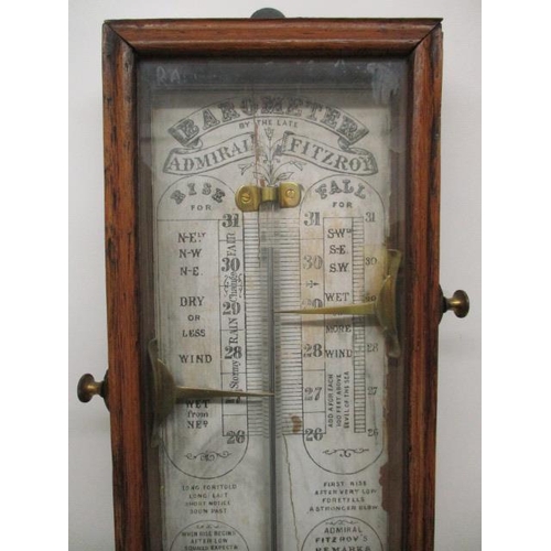 132 - A Victorian Admiral Fitzroy barometer with a printed paper and walnut backing with brass markers, in... 