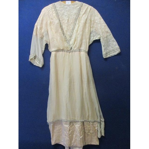 82 - A 1903 wedding dress in a pale peach silk and lace with beaded trim, purchased from the costume depa... 