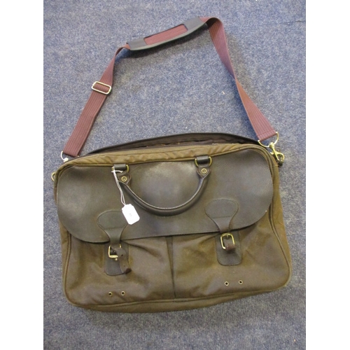 60 - A Barbour wax and leather Tarras messenger bag with a Barbour tartan lining and two large bellow poc... 