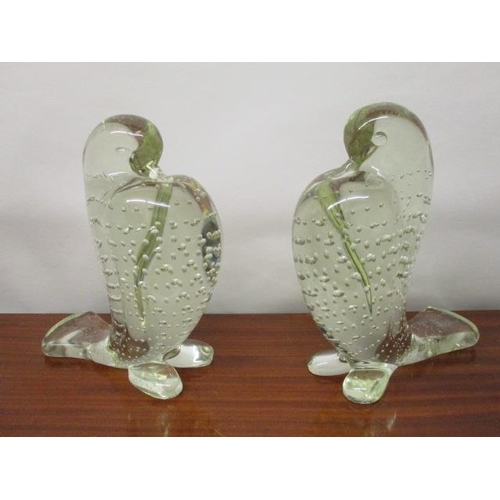 173 - A pair of Murano clear glass model doves with puffed out chests and bubble decoration, each with a l... 