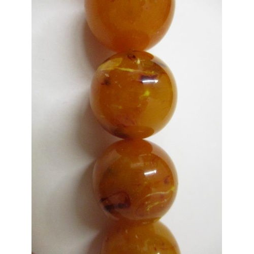 176 - An egg yolk coloured Bakelite necklace with thirty seven beads, 141g