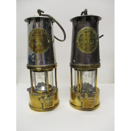 179 - Two Protector Lamp & Lighting Co polished steel and brass miners safety lamps, one Type 6, stamped N... 