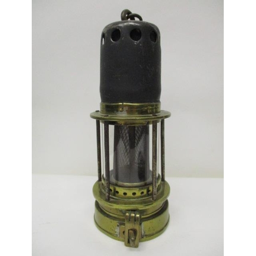 182 - A Patterson 'Donald' steel and brass miners safety lamp with a gauze within a glass panel, 8 1/2