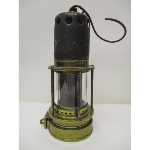 182 - A Patterson 'Donald' steel and brass miners safety lamp with a gauze within a glass panel, 8 1/2