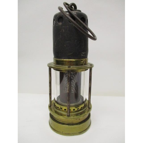 182 - A Patterson 'Donald' steel and brass miners safety lamp with a gauze within a glass panel, 8 1/2