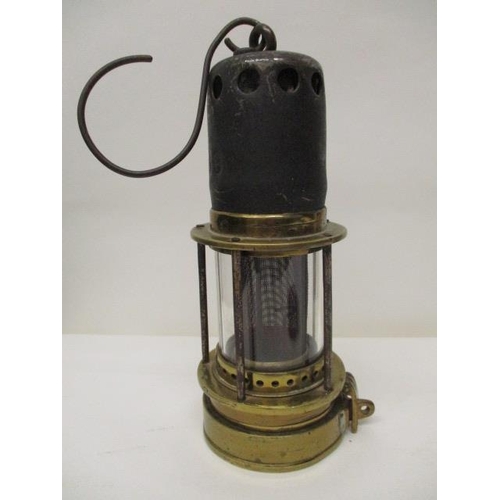 182 - A Patterson 'Donald' steel and brass miners safety lamp with a gauze within a glass panel, 8 1/2