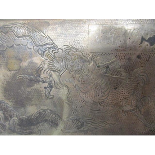 195 - A mid 20th century Chinese silver coloured metal cigarette case, engraved with a dragon on a spot ha... 