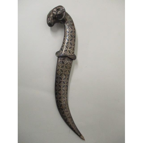 66 - An Indian Niello white metal dagger with a Damascus curved blade, rams head pommel and Niello sheath... 