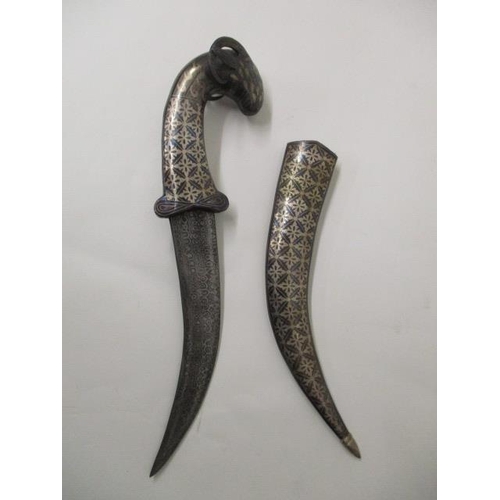 66 - An Indian Niello white metal dagger with a Damascus curved blade, rams head pommel and Niello sheath... 