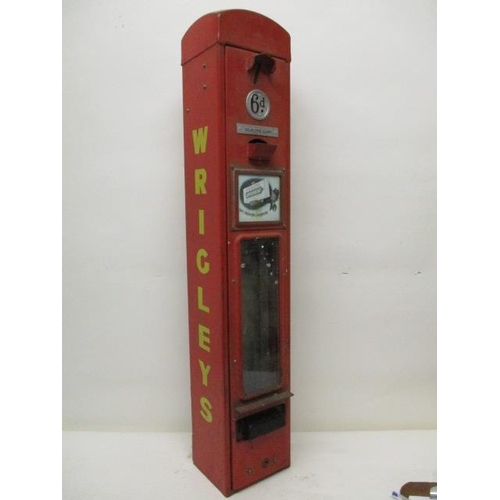 74 - A Wrigley's chewing gum, red painted advertising, dispensing machine   with a coin slot, 6d badge, a... 