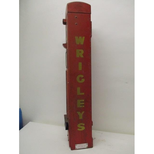 74 - A Wrigley's chewing gum, red painted advertising, dispensing machine   with a coin slot, 6d badge, a... 