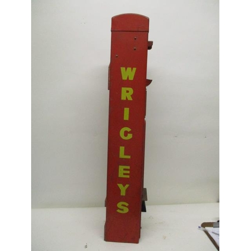 74 - A Wrigley's chewing gum, red painted advertising, dispensing machine   with a coin slot, 6d badge, a... 