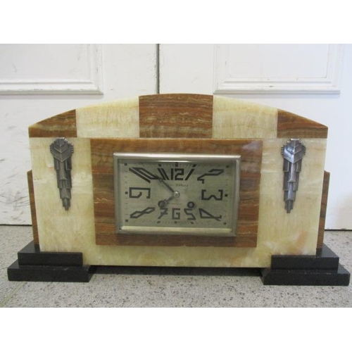 22 - An Art Deco marble mantle clock with two matching garniture, the rectangular dial marked Paul Aubois... 