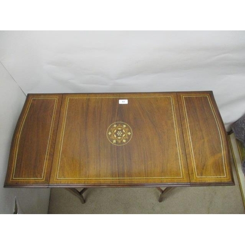 63 - A late Victorian string inlaid, rosewood and marquetry occasional table with twin fall flaps and a d... 