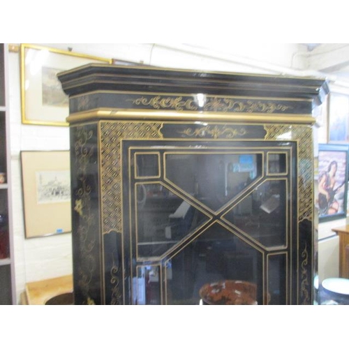 137 - A black chinoiserie corner cabinet