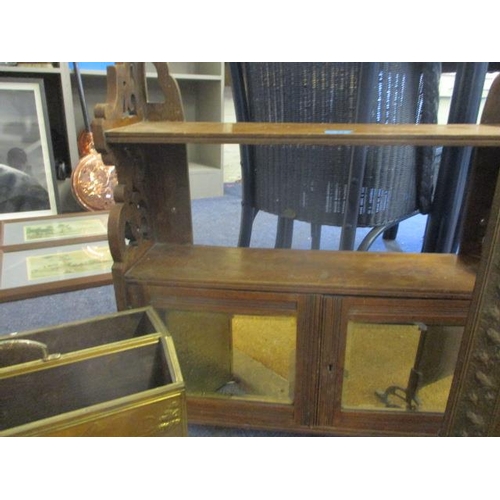 74 - An early 20th century mahogany wall shelf with cupboard below, a brass fire guard and brass magazine... 