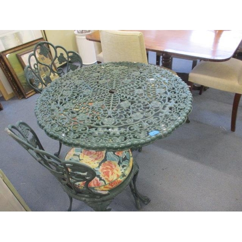 85 - A modern green metal bistro table and two matching chairs with cushions