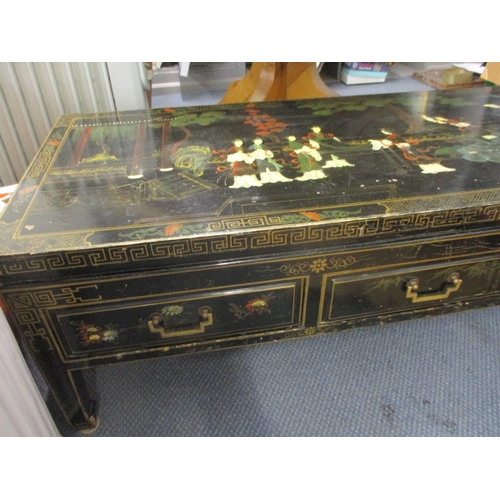 119 - An Oriental three drawer coffee table with japanned decoration on square tapering legs with spade fe... 