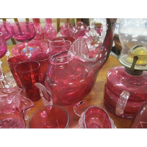 238 - A collection of early to mid 20th century cranberry glassware to include an oil lamp