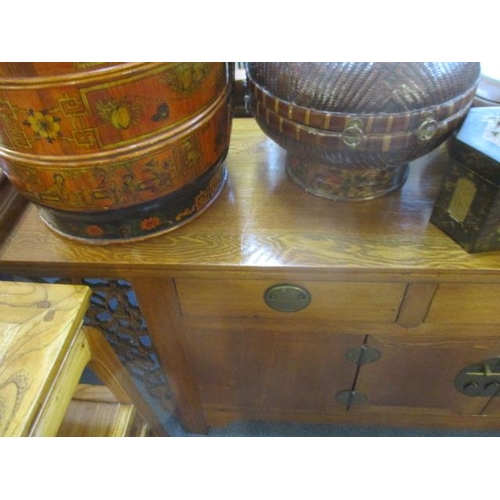 244 - A Chinese oak scroll desk with three short drawers and cupboards below flanked by pierced floral bra... 