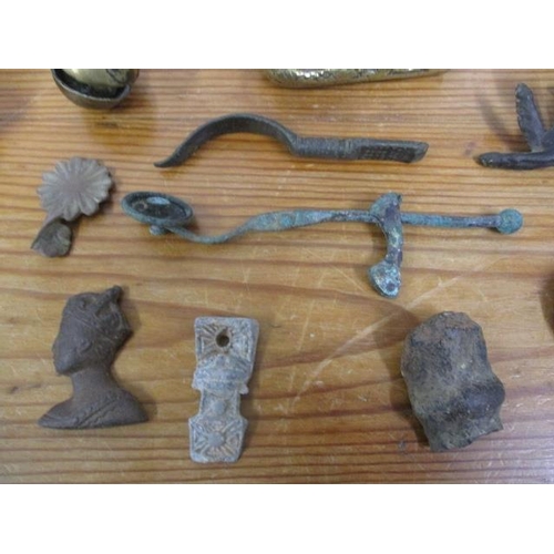 262 - Antique, Roman and other metal detectorists finds to include rams bells, A Roman copper alloy spatul... 