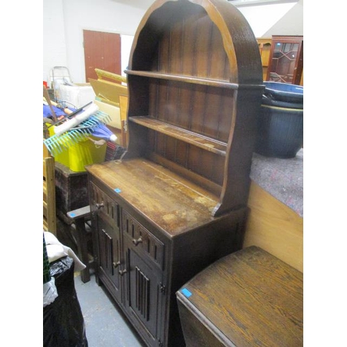 285 - A 1930s oak drop leaf dining table on barley twist legs, and a mid 20th century oak Dutch style dres... 